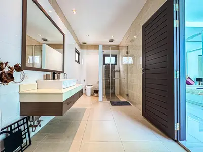a bathroom with a sink and a shower and a mirror at VILLA DESTINY - Luxury Villa Near Nai Harn Beach in Ban Saiyuan (1)