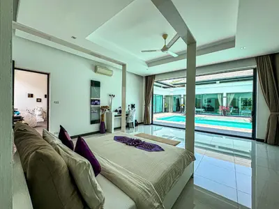 a living room with a bed and a swimming pool at VILLA DESTINY - Luxury Villa Near Nai Harn Beach in Ban Saiyuan (1)