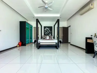 a bedroom with a bed and a ceiling fan at VILLA DESTINY - Luxury Villa Near Nai Harn Beach in Ban Saiyuan (1)