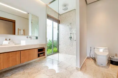 a bathroom with a toilet and a sink and a shower at Stylish Pool Villa Tropical Hideaway in Ban Phru Champa