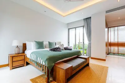 a white bedroom with a bed and a window at Stylish Pool Villa Tropical Hideaway in Ban Phru Champa