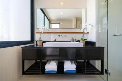 a bathroom with a sink and a mirror at Laguna pool house in Phuket Town