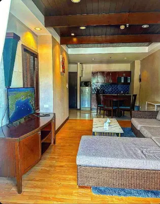 a living room with a couch and a flat screen tv at Patong Tower Mountain View in Patong Beach