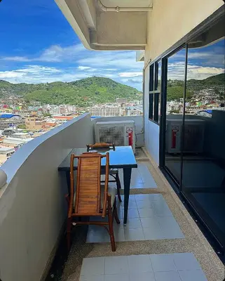 a table and chairs on a balcony with a view at Patong Tower Mountain View in Patong Beach