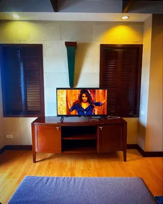 a room with a table with a tv on it at Patong Tower Mountain View in Patong Beach