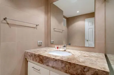 a bathroom with a sink and a mirror at Mountain View Apt, High Speed Internet - 1BR-Karon in Kata Beach