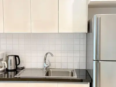 a kitchen with a sink and white cabinets at Kamala Falls A3-4 IBG Property in Kamala Beach
