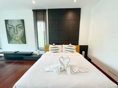a bedroom with a bed with two white bows at Kamala Falls A3-4 IBG Property in Kamala Beach
