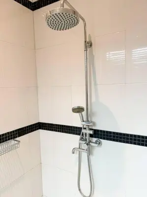 a shower in a bathroom with black and white tiles at Kamala Falls A3-4 IBG Property in Kamala Beach