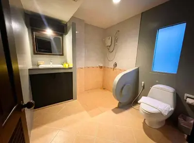 a bathroom with a toilet and a sink at Fullmoon Beachresort Krabi in Ao Nang Beach