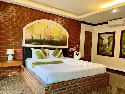 a bedroom with a large bed in a brick wall at Fullmoon Beachresort Krabi in Ao Nang Beach