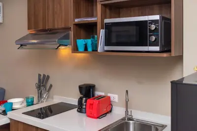 a kitchen with a sink and a microwave at NOVA Condo 1BR Pool View NBC Nai Harn in Rawai Beach