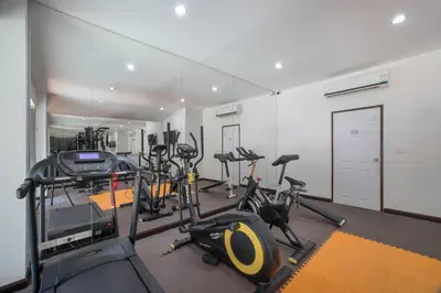 a gym with several treadmills and exercise bikes at NOVA Condo 1BR Pool View NBC Nai Harn in Rawai Beach
