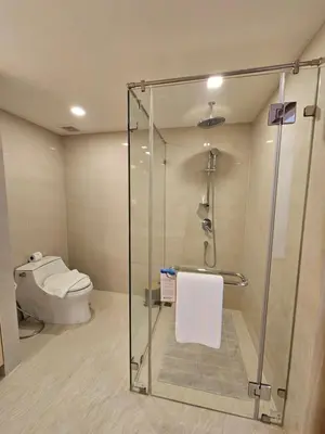 a bathroom with a shower and a toilet at Duplex Luxury Apartments in 5 Star Hotel in Rawai Beach
