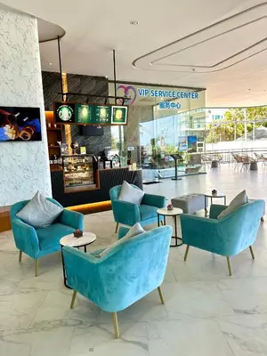 a lobby with blue chairs and tables in a store at Duplex Luxury Apartments in 5 Star Hotel in Rawai Beach