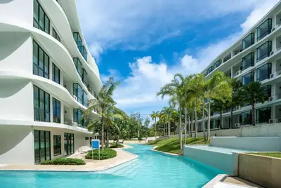 a swimming pool in front of a building at Duplex Luxury Apartments in 5 Star Hotel in Rawai Beach