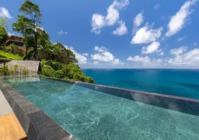 a swimming pool with a view of the ocean at Villa Yin, Private Oceanfront Villa, Kamala Beach in Kamala Beach