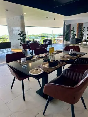 a dining room with tables and chairs in a restaurant at La Vita Luxury Apartment in Rawai Beach
