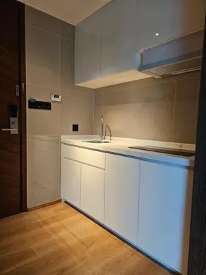 a kitchen with white cabinets and a sink at La Vita Luxury Apartment in Rawai Beach