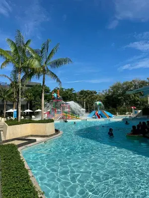 a pool at a water park with people in it at La Vita Luxury Apartment in Rawai Beach