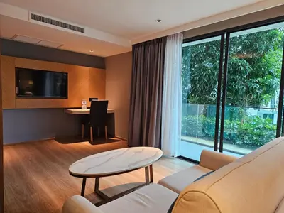 a living room with a couch and a table and a desk at La Vita Luxury Apartment in Rawai Beach