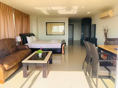 a living room with a couch and a bed at Ocean View Treasure Residence in Patong Beach