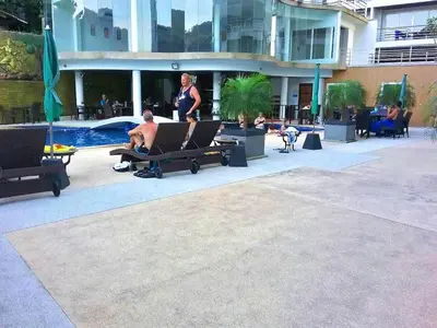 a woman standing next to a man sitting on a bench at Ocean View Treasure Residence in Patong Beach