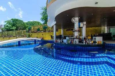 a pool at a hotel with a bar in it at Ocean View Treasure Residence in Patong Beach