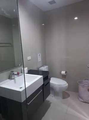 a white bathroom with a sink and a toilet at The Deck Patong 7Fl Mountain View2 in Patong Beach