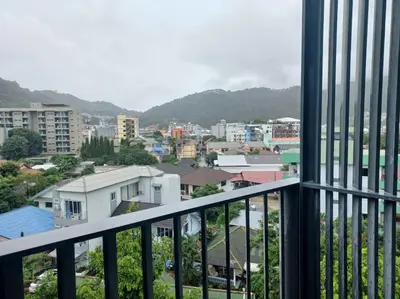 a view of a city from a balcony at The Deck Patong 7Fl Mountain View2 in Patong Beach