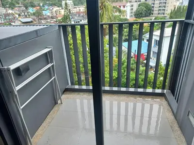 a balcony with a stove and a view of a city at The Deck Patong 7Fl Mountain View2 in Patong Beach