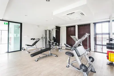 a gym with several exercise bikes in a room at 6th Avenue Surin Condomium in Surin Beach