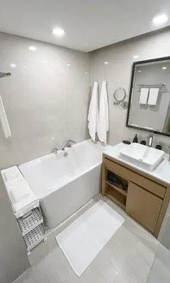 a white bathroom with a tub and a sink at Apartment 5 Star Hotel LaVita in Rawai Beach