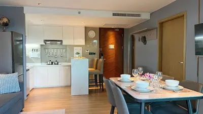 a kitchen and a dining room with a table and chairs at Apartment 5 Star Hotel LaVita in Rawai Beach