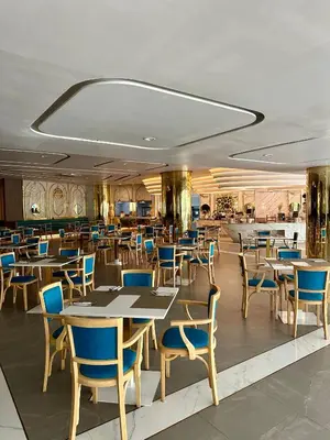a restaurant with tables and chairs in a room at Apartment 5 Star Hotel LaVita in Rawai Beach