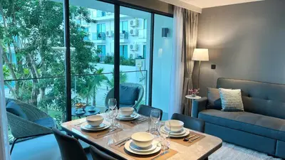 a dining room with a table and a couch at Apartment 5 Star Hotel LaVita in Rawai Beach