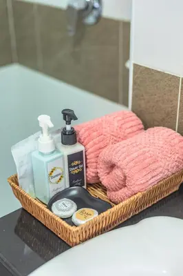 a basket of bathroom items sitting on a counter at \u592a\u9633\u82b1\u9152\u5e97\u4eb2\u5b50\u5957\u623f in Patong Beach
