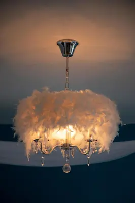 a chandelier with a bunch of feathers on it at \u592a\u9633\u82b1\u9152\u5e97\u4eb2\u5b50\u5957\u623f in Patong Beach