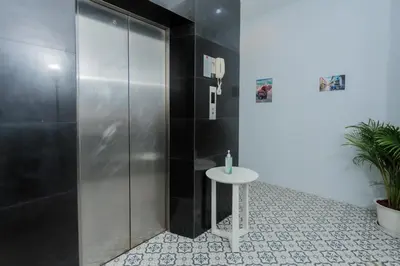 a shower stall with a table in a bathroom at \u592a\u9633\u82b1\u9152\u5e97\u4eb2\u5b50\u5957\u623f in Patong Beach