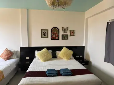 a bedroom with a bed with two blue towels on it at \u592a\u9633\u82b1\u9152\u5e97\u4eb2\u5b50\u5957\u623f in Patong Beach