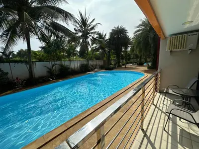 a swimming pool on the balcony of a house at 1 - Bedroom Apartment Pool Access, 750m to the Beach in Mai Khao Beach