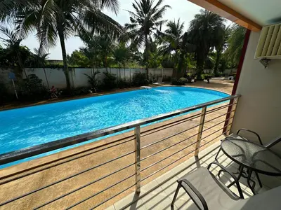 a swimming pool on the balcony of a house at 1 - Bedroom Apartment Pool Access, 750m to the Beach in Mai Khao Beach