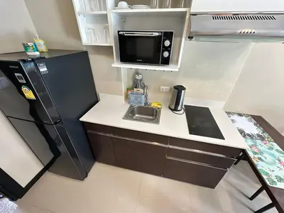 a small kitchen with a sink and a refrigerator at 1 - Bedroom Apartment Pool Access, 750m to the Beach in Mai Khao Beach