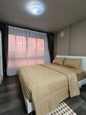 a bedroom with a large bed and a window at D-Condo Mine Kathu in Ban Ket Ho