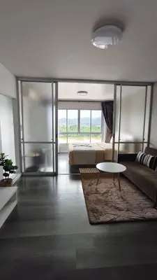 a living room with a bed and a coffee table at D-Condo Mine Kathu in Ban Ket Ho