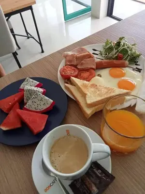 a breakfast of eggs and toast and a cup of coffee at Kata Beach Poshtel Phuket in Kata Beach