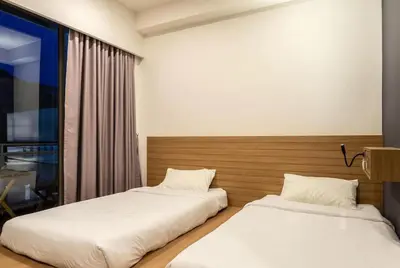 two beds sitting next to each other in a room at Kata Beach Poshtel Phuket in Kata Beach