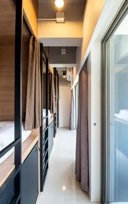 a narrow hallway in a tiny house at Kata Beach Poshtel Phuket in Kata Beach
