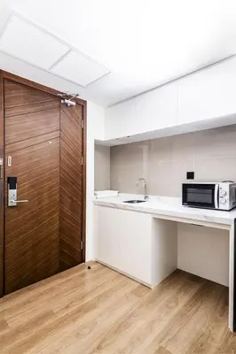 a kitchen with a sink and a microwave on a counter at Suite Marella 1BR Pools Shuttle to Nai Harn in Rawai Beach