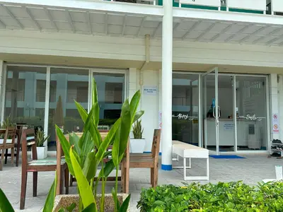 an office building with tables and chairs and windows at Blue Horizon Hostel By Blue Flow in Phi Phi Don